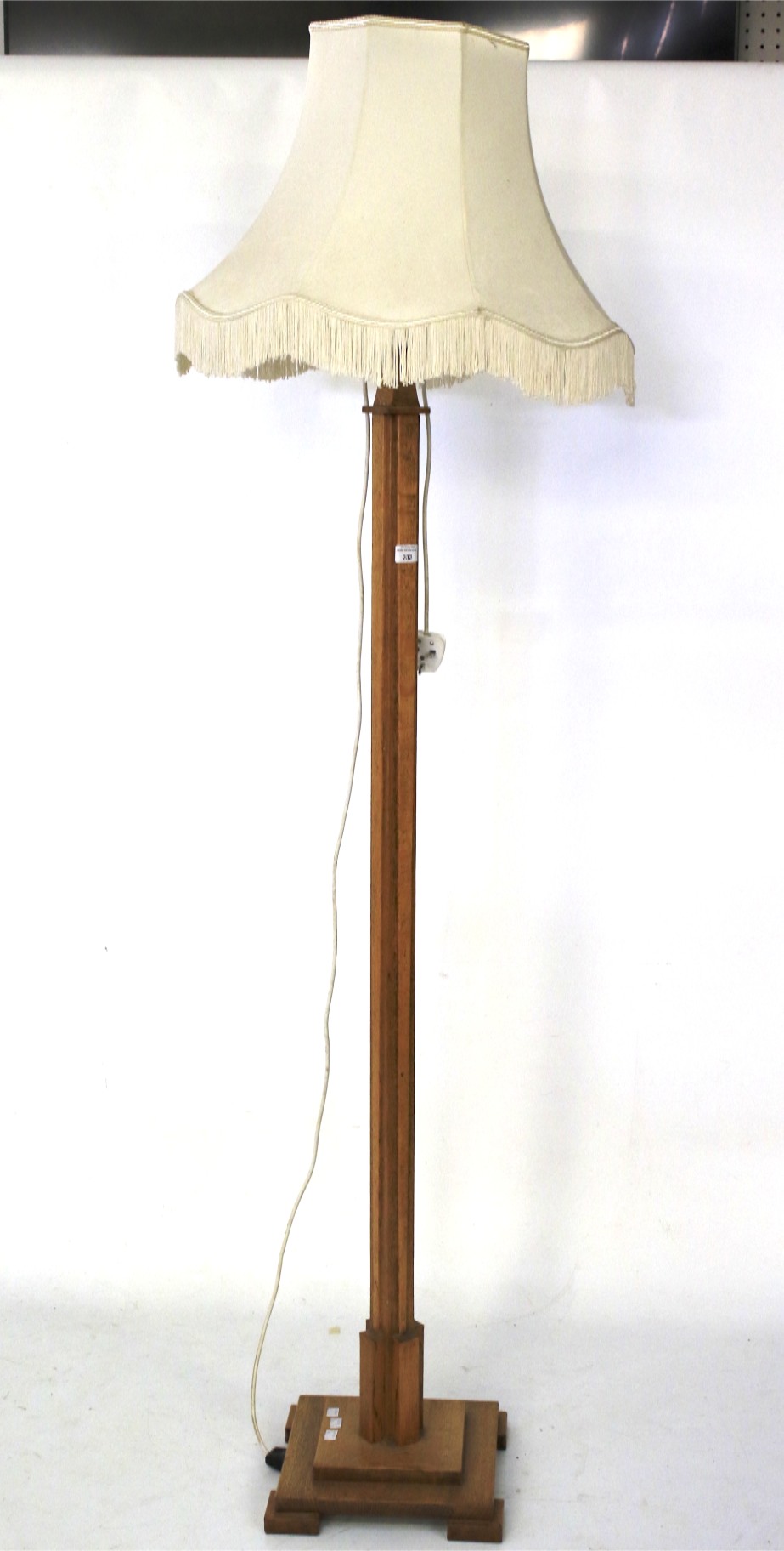 An Art Deco light oak standard lamp.