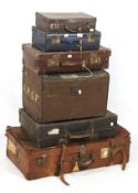 Six vintage leather suitcases.