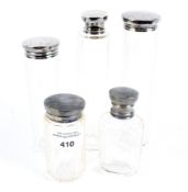 A set of five silver topped glass bottle containers.