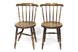 A pair of Victorian stick back elm dining chairs.