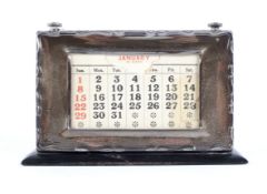A vintage silver mounted perpetual desk calendar.