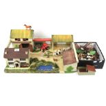 A vintage scratch built wooden toy farmyard with a collection of farm animals.