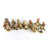 Seventeen Goebel Hummel figurines.