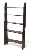 A red painted pine waterfall bookcase. In two sections, L76cm x D19.