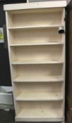 A white painted pine kitchen shelf unit. Free standing with five fixed shelves.