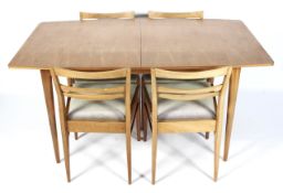 A McIntosh 1960s teak rectangular extending dining table and four dining chairs.