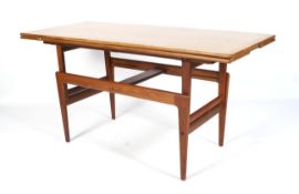A 1960s metamorphic teak extending dining table/coffee table.