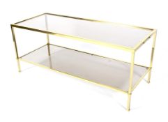 A retro gilt-metal and smoky-grey glass topped coffee table.