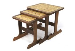 A 1970s nest of three tile top tables.