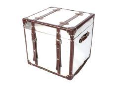 A polished leather bound metal trunk.