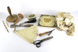 An assortment of lace and sewing equipment.