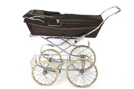 A Silver Cross vintage 1970s pram baby carriage. With four-wheel folding chrome frame.