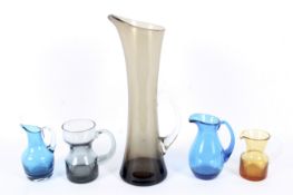 Five Whitefriars glass jugs in sizes.
