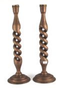 A pair of large wooden candlesticks. Painted bronze with double twist columns. 63cm high.