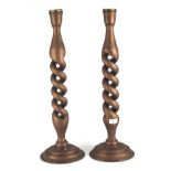 A pair of large wooden candlesticks. Painted bronze with double twist columns. 63cm high.