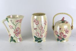 Three matching Maling pink lustre blossom ware. A jug, biscuit barrel and a vase 20.