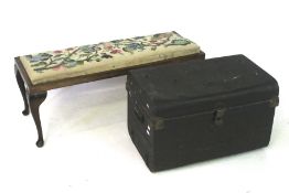 A green Japanned travelling trunk and an embroidered top footstool.