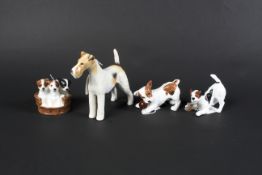 Three Royal Doulton dog figurines and a Beswick dog figurine.