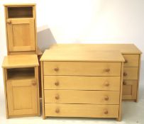 A set of five matching items of beech effect bedroom furniture.