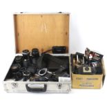 A quantity of assorted film camera equipment in an aluminium camera case.