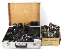 A quantity of assorted film camera equipment in an aluminium camera case.