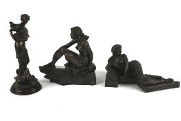 Three bronzed resin female figurines.
