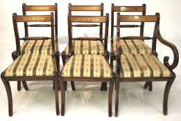 A set of 20th century mahogany and brass inlaid Regency style dining chairs.