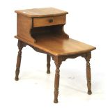 A mid-century Cambridge light oak two tier telephone table with small drawer.