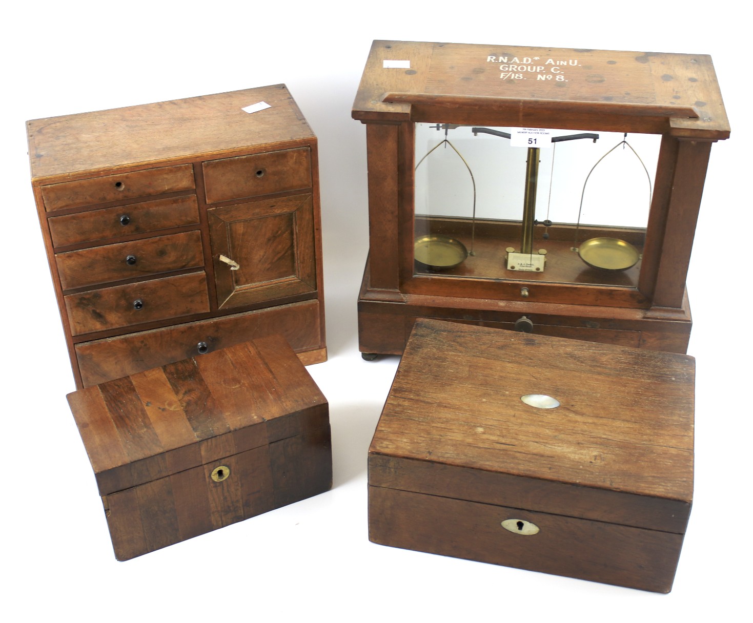 A pair of weighing scales, two wooden boxes and an apprentice miniature chest of drawers.