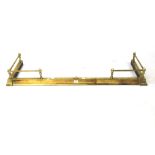 A brass adjustable fire fender. With corner rods set within three finials,