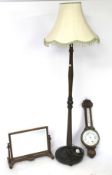 A standard lamp, mirror and a barometer.
