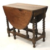 A 20th century oak gateleg table. With oval top on turned baluster supports, L88.