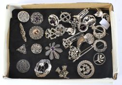 A collection of Scottish silver and white metal brooches.