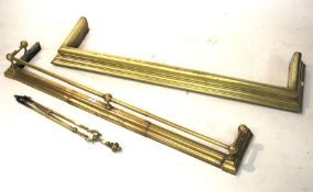 Two brass fenders and a part fire companion set.
