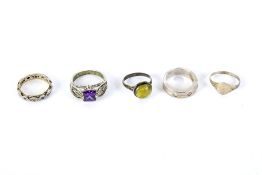 Five silver rings. Some set with stones, others with engraved and embossed decoration,