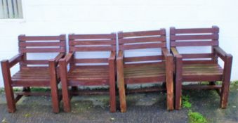 A set of four heavy wooden garden chairs.