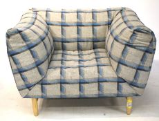 A Spanish Sancal armchair upholstered in white and blue checked fabric.