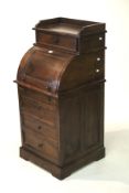 A small contemporary hardwood roll top bureau with drawers.