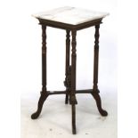 An Edwardian white marble topped wine table with cross stretcher.