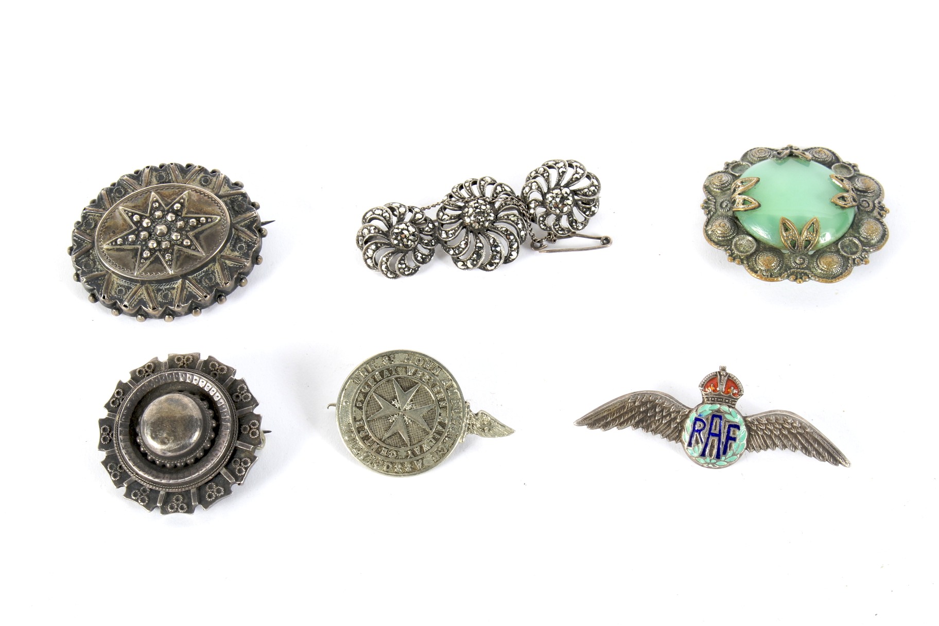 Six vintage silver and white metal brooches.