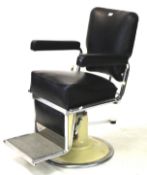 A La Reine Restocrat vintage barbers chair with cream enamel hydraulic base.