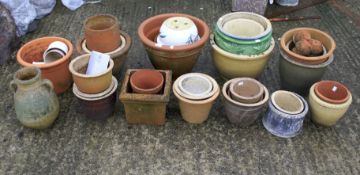A collection of terracotta and glazed garden pots.
