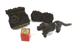 A cast iron nut cracker in the shape of a dog, two printing blocks and a boxed gyroscope.