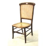 A Victorian oak framed caned chair.