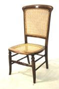 A Victorian oak framed caned chair.