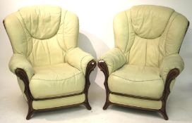 A pair of contemporary elbow chairs.