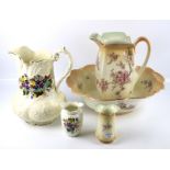 A Victorian ceramic three piece wash set with pink blossom design, a pitcher and a vase.