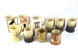 Two reproduction promotional Guinness water jugs and several ceramic tankards