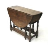 An early 19th century oak gate leg table with single drawer (missing).