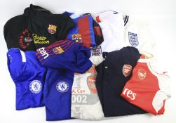 Twelve contemporary football shirts and sweatshirts.